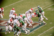 Bernie Kosar hands off to Tim Manoa