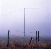 Fence and pylon in the fog