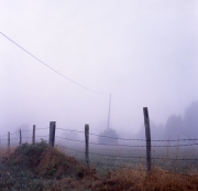 Fence and pylon in the fog