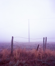 Fence and pylon in the fog