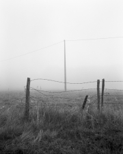 Fence and pylon in the fog