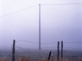 Fence and pylon in the fog