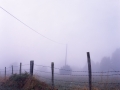 Fence and pylon in the fog